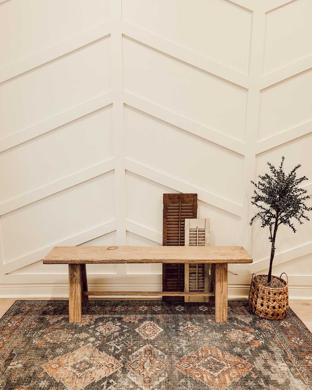 completed DIY aged wood bench styled in the entryway of a modern farmhouse
