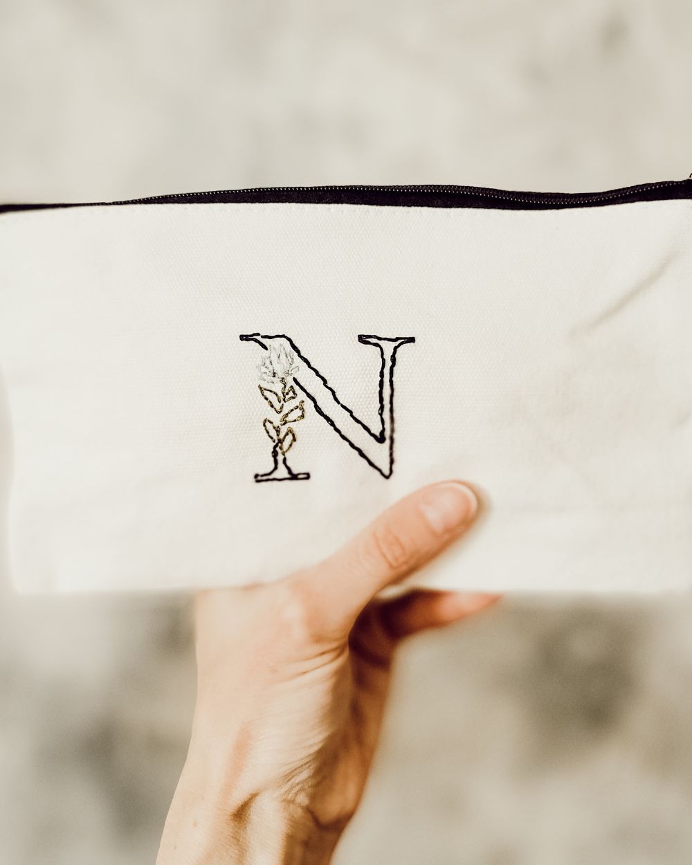a completed embroidered zipper pouch using transfer paper