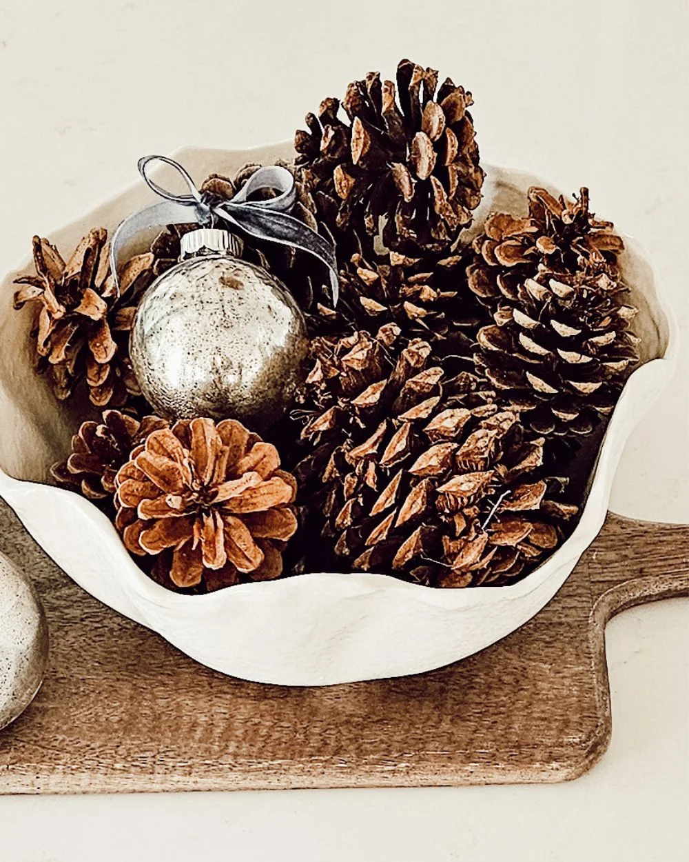 DIY mercury ornament in a bowl of pinecones